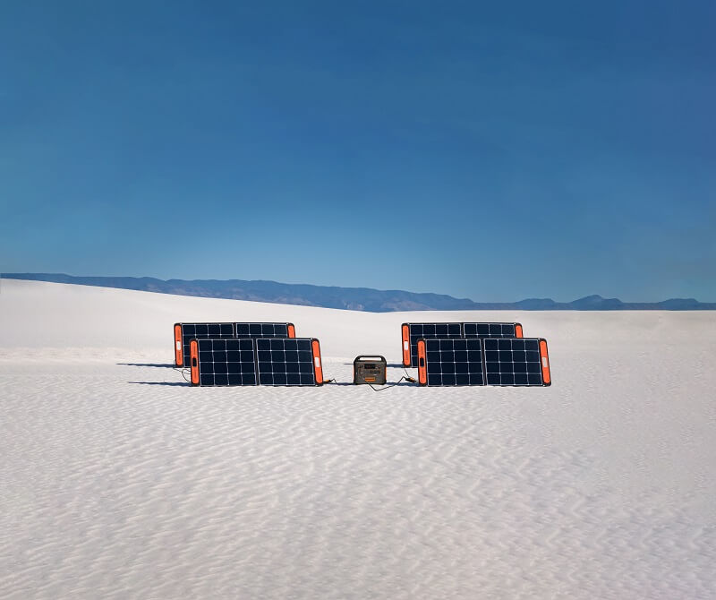 solar panels surrounded by a vast landscape of snow